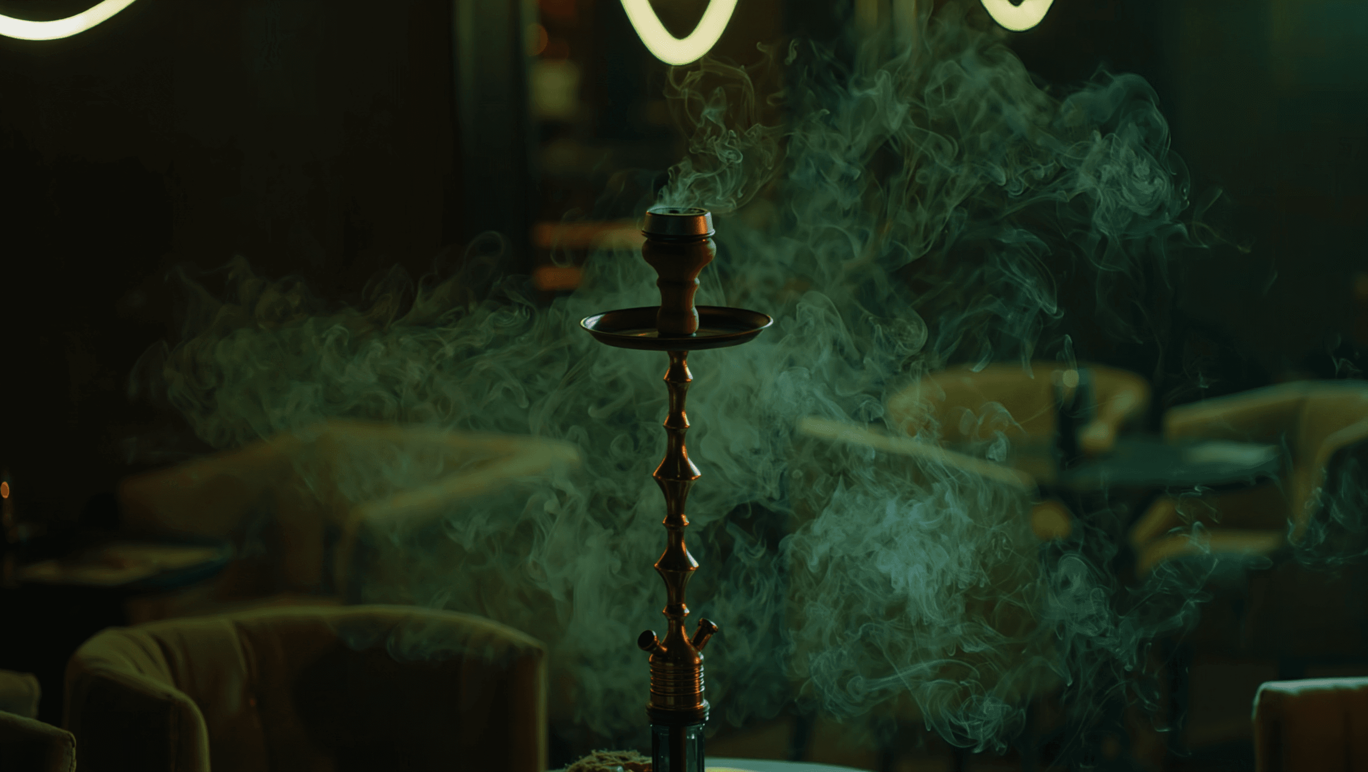 Dark hookah lounge interior with green neon light and smoke